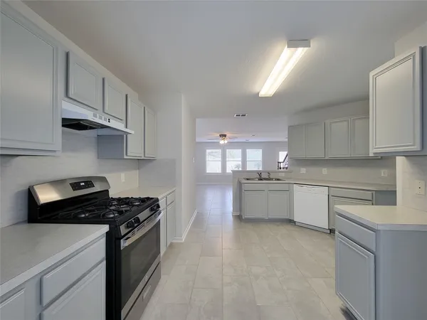 a kitchen with stainless steel appliances a refrigerator sink and stove