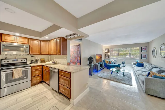 a kitchen with a stove a sink a oven a dining table and chairs