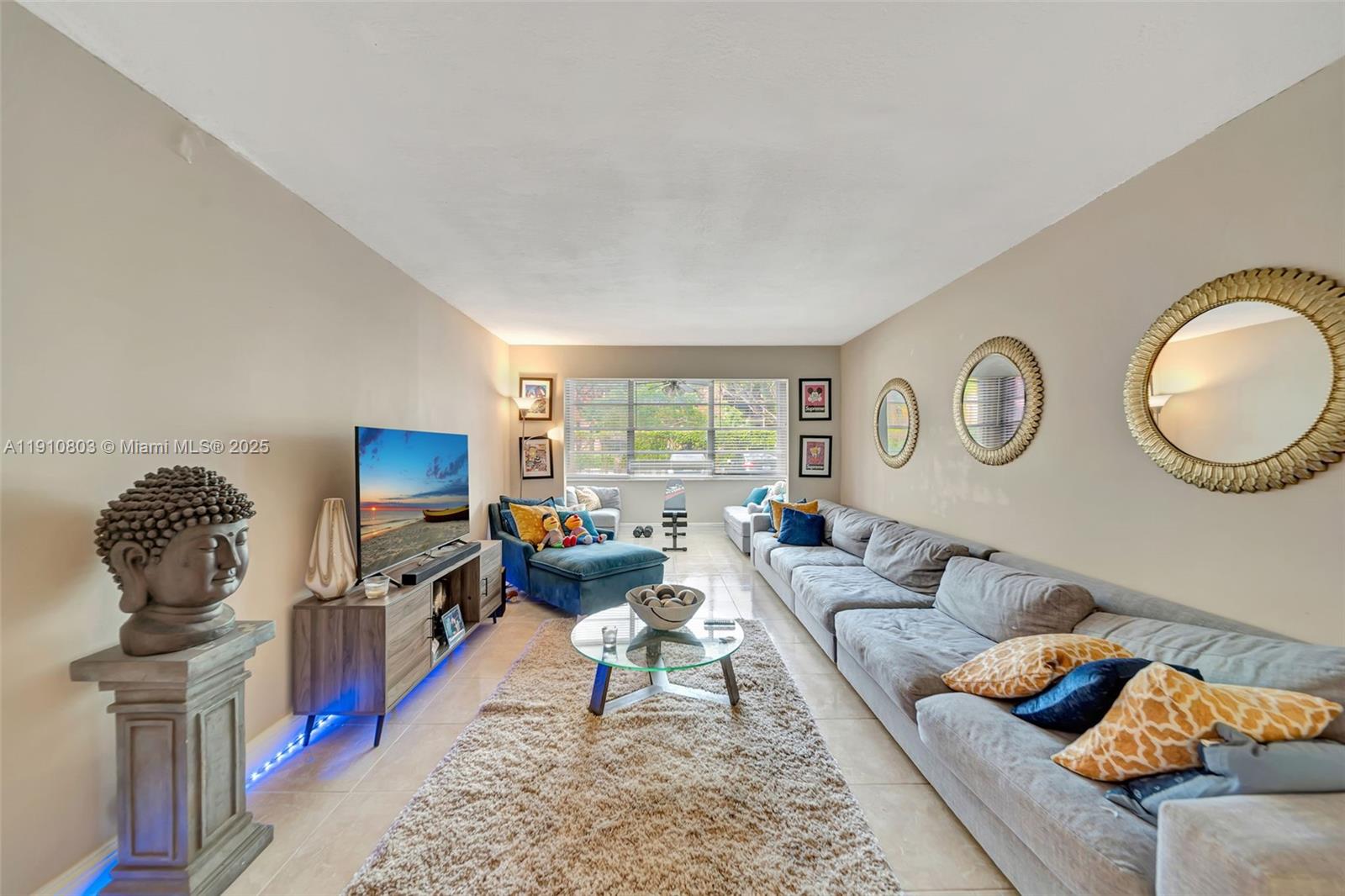 6700 Cypress Road, Unit 105 Plantation, FL 33317 - Photo 11 of 28 a living room with furniture a rug and a flat screen tv
