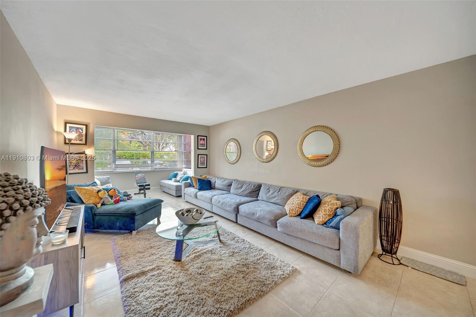 6700 Cypress Road, Unit 105 Plantation, FL 33317 - Photo 12 of 28 a living room with furniture and a large window