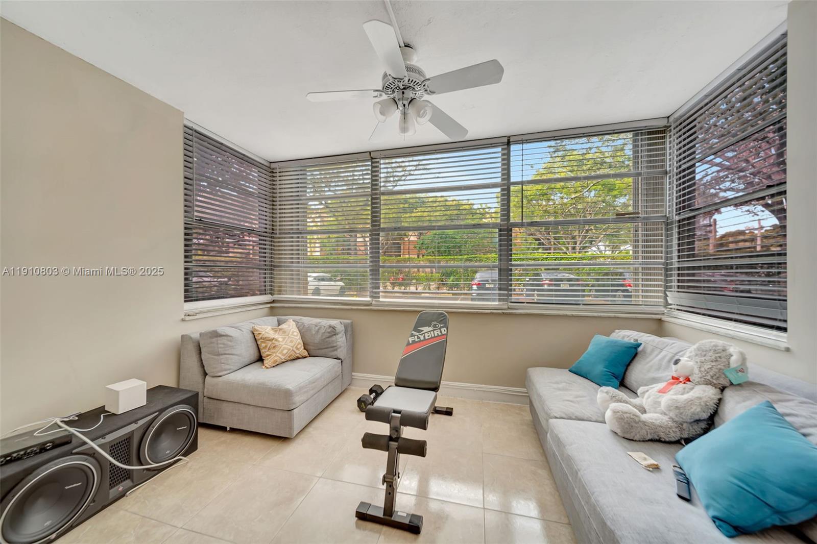 6700 Cypress Road, Unit 105 Plantation, FL 33317 - Photo 13 of 28 a living room with furniture and a large window