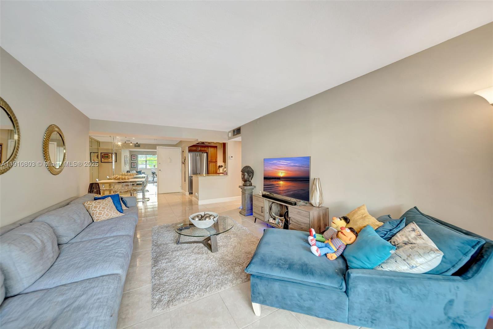 6700 Cypress Road, Unit 105 Plantation, FL 33317 - Photo 14 of 28 a living room with furniture and a flat screen tv with wooden floor