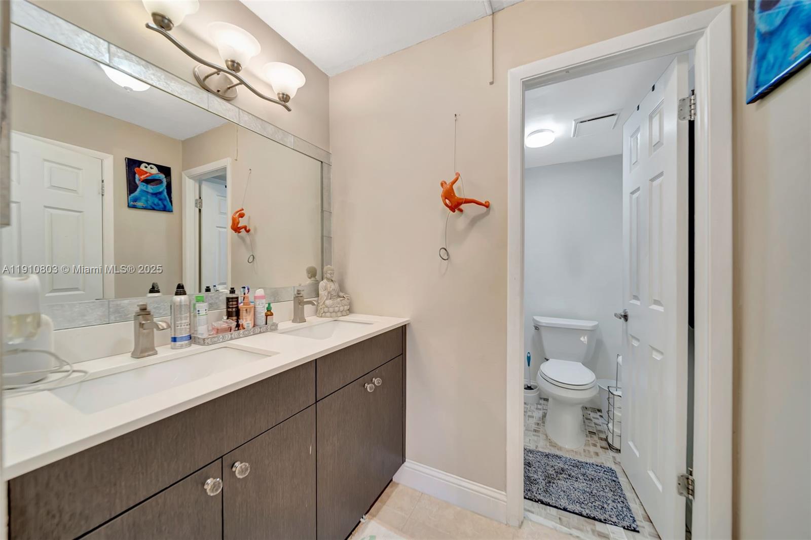 6700 Cypress Road, Unit 105 Plantation, FL 33317 - Photo 20 of 28 a bathroom with a sink a toilet and a mirror