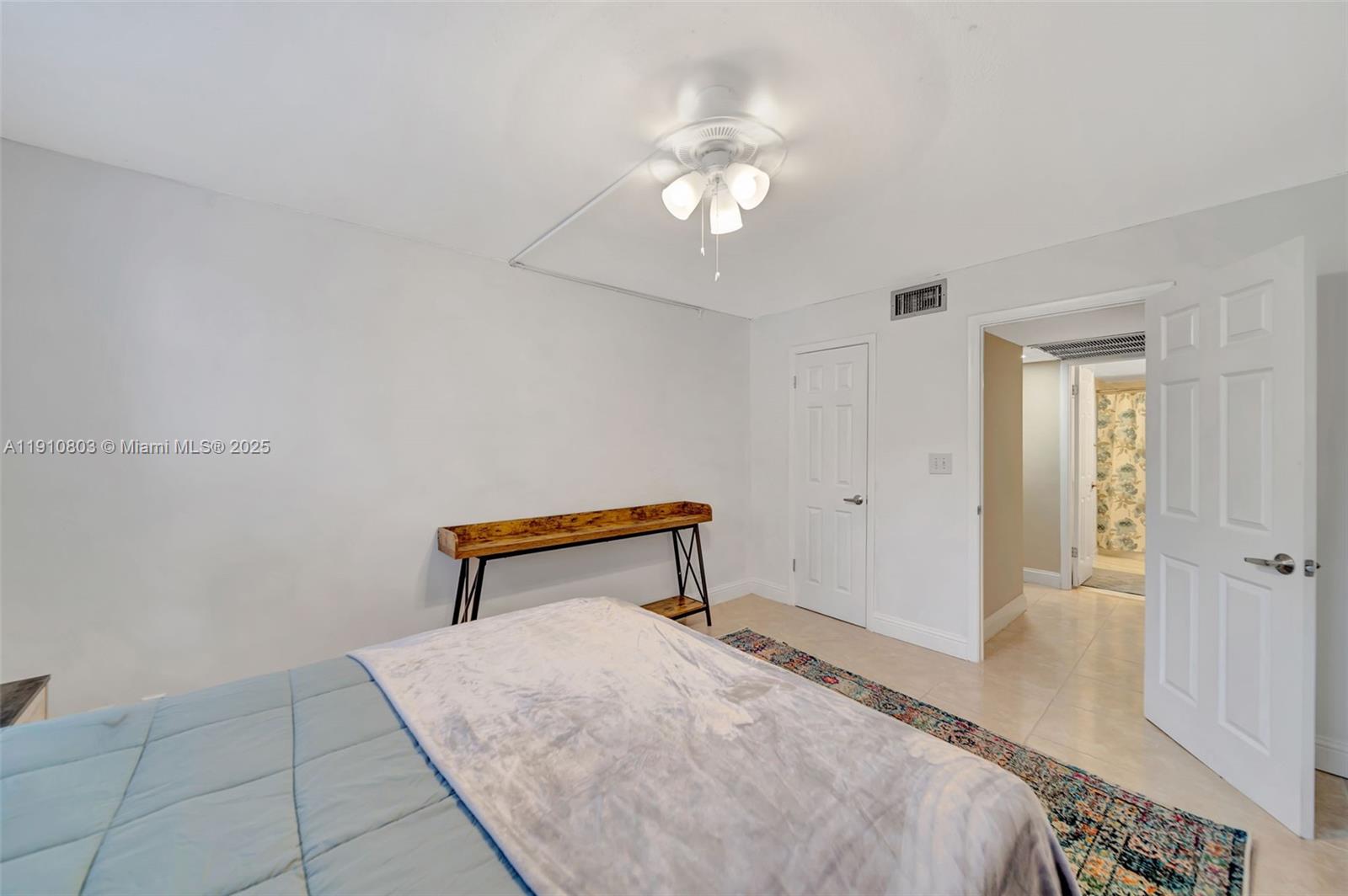 6700 Cypress Road, Unit 105 Plantation, FL 33317 - Photo 25 of 28 a bedroom with a bed and a chandelier