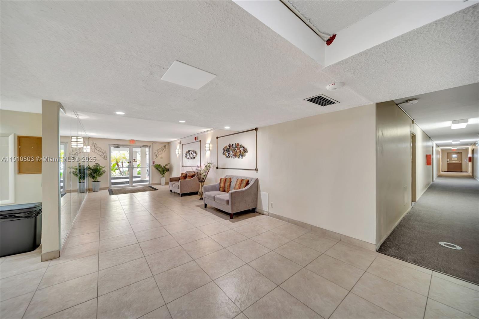 6700 Cypress Road, Unit 105 Plantation, FL 33317 - Photo 27 of 28 a lobby with furniture and a gate