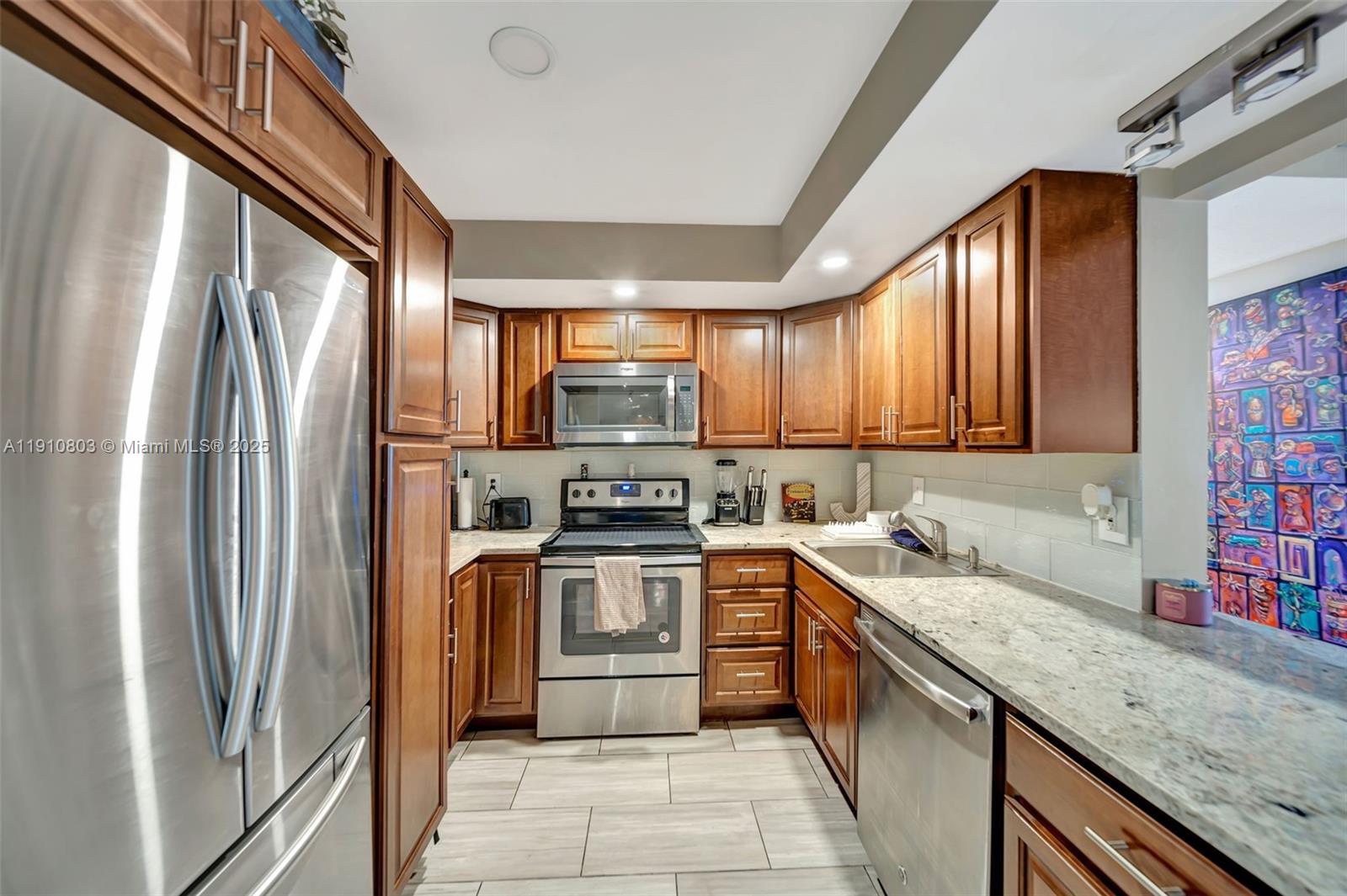 6700 Cypress Road, Unit 105 Plantation, FL 33317 - Photo 5 of 28 a kitchen with stainless steel appliances granite countertop a refrigerator sink and stove