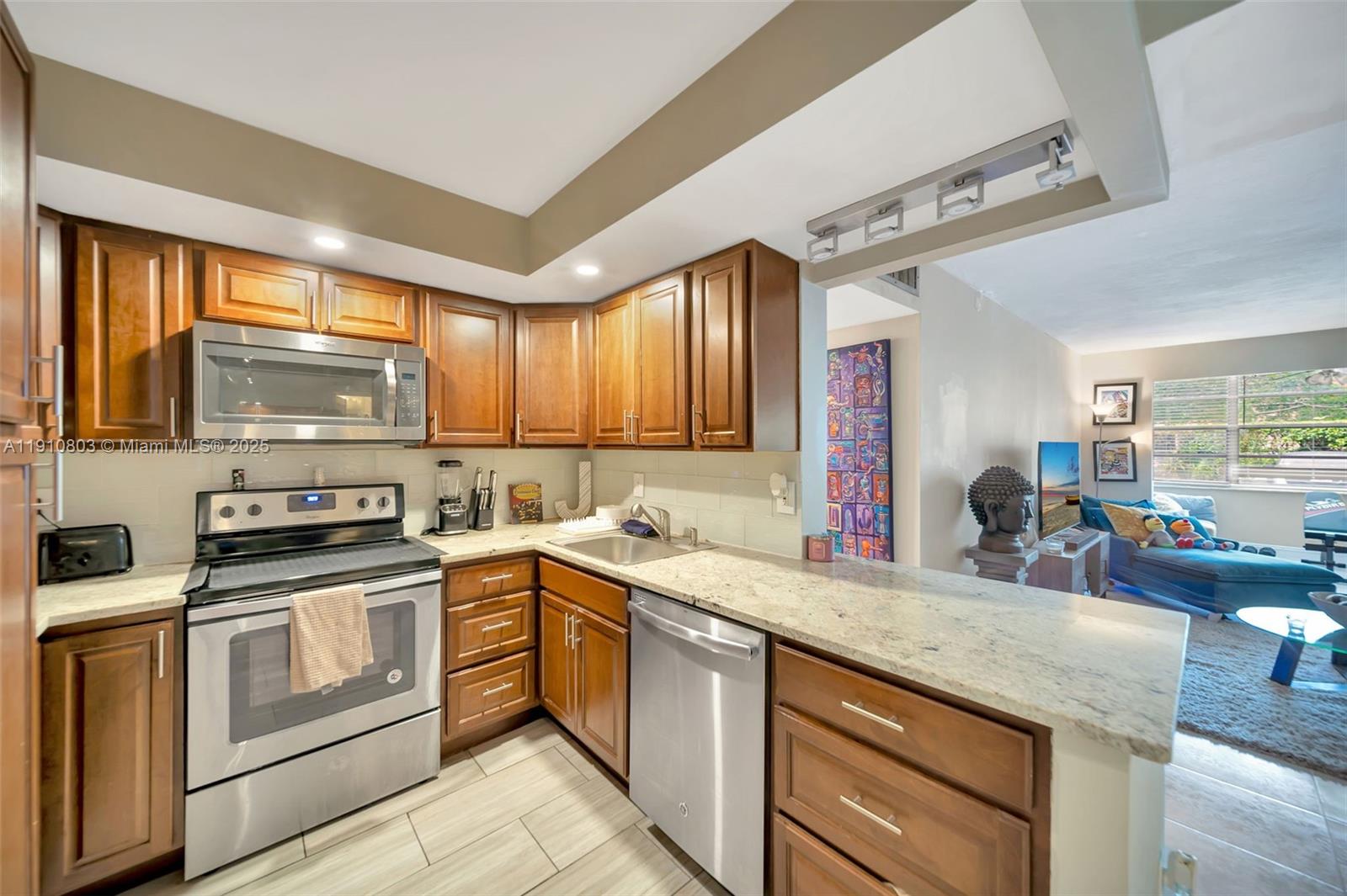 6700 Cypress Road, Unit 105 Plantation, FL 33317 - Photo 6 of 28 a kitchen with stainless steel appliances granite countertop a sink stove and oven