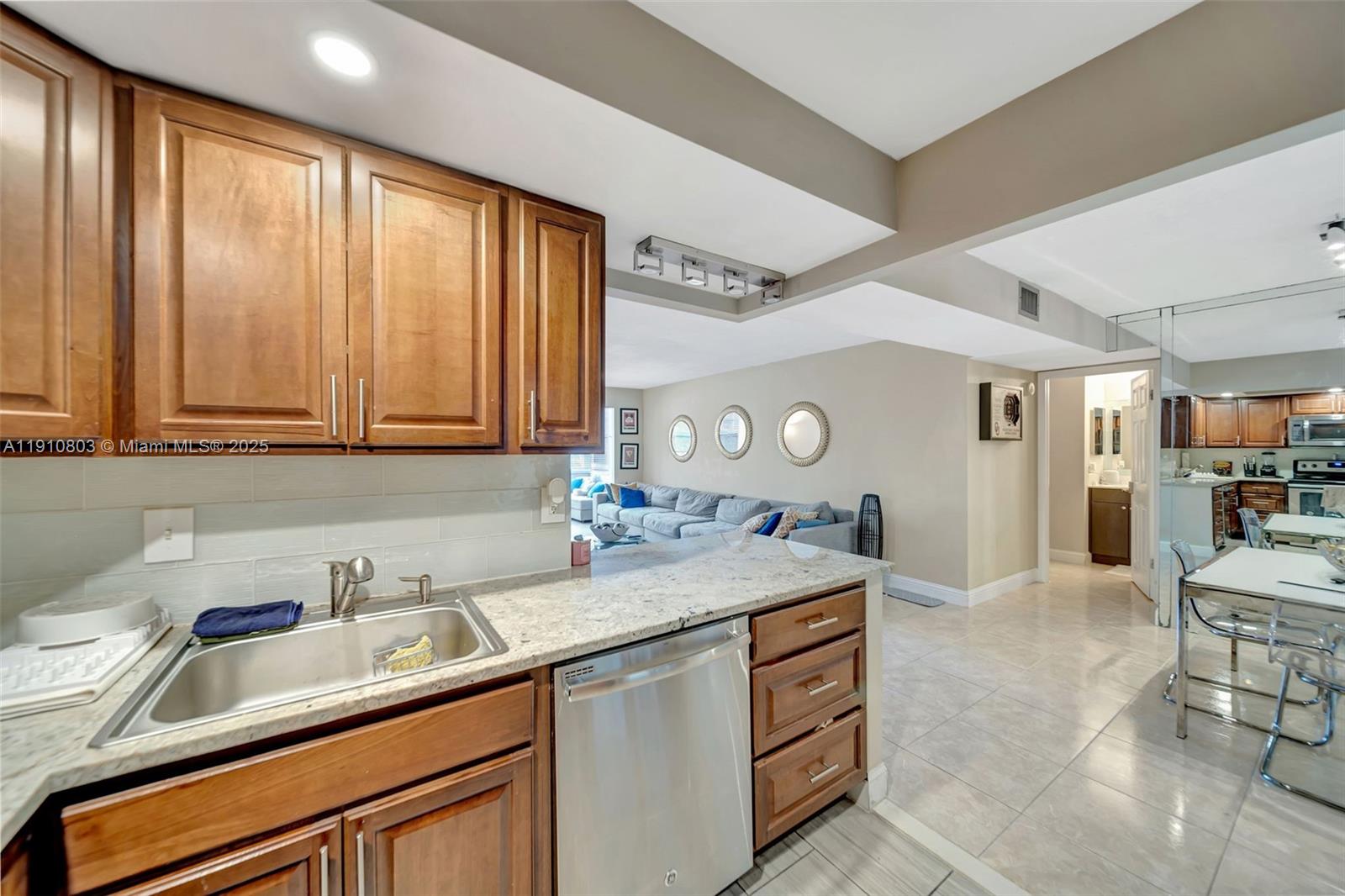 6700 Cypress Road, Unit 105 Plantation, FL 33317 - Photo 7 of 28 a kitchen with stainless steel appliances granite countertop a sink and cabinets