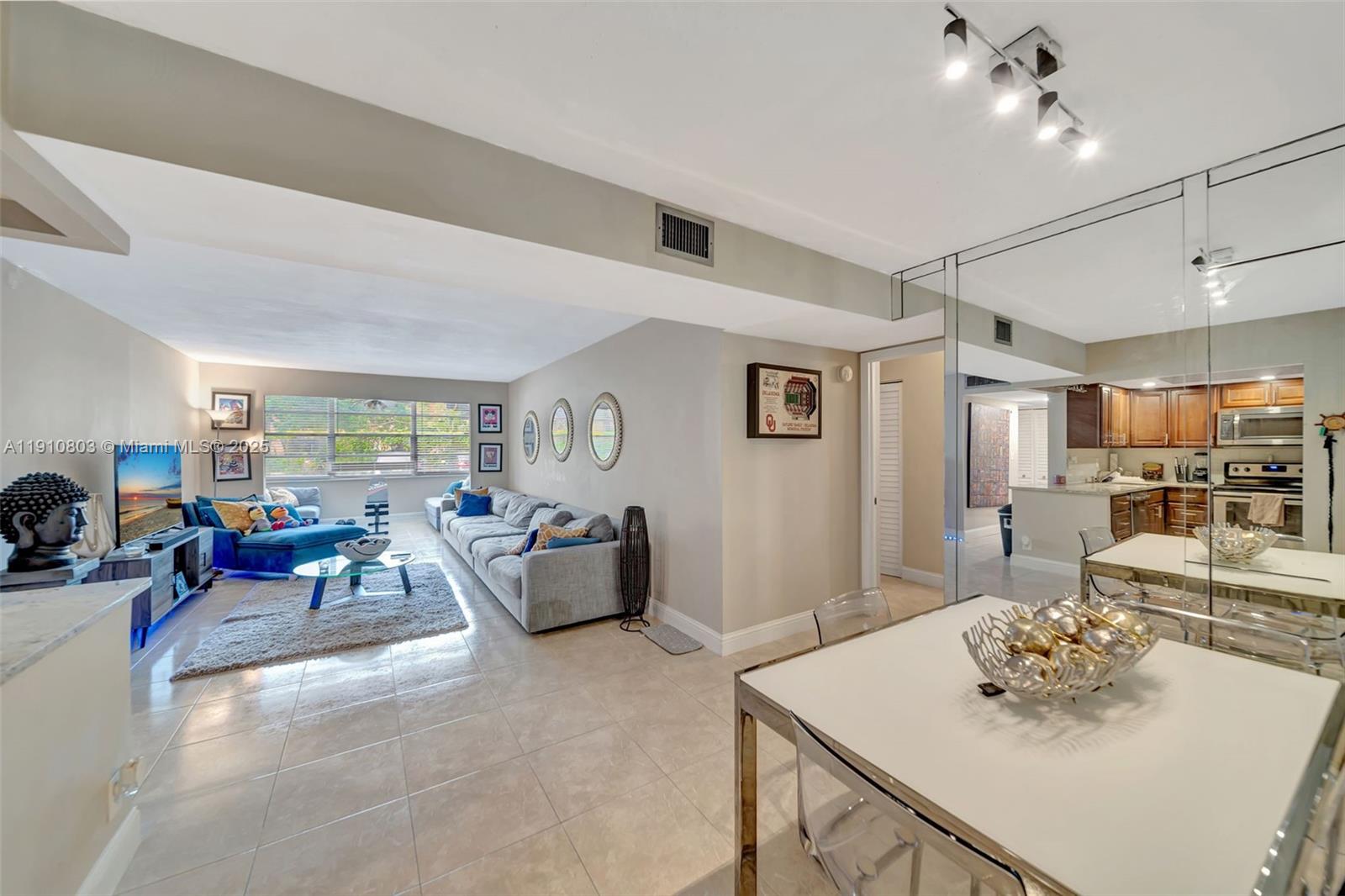 6700 Cypress Road, Unit 105 Plantation, FL 33317 - Photo 9 of 28 a living room with furniture and a table
