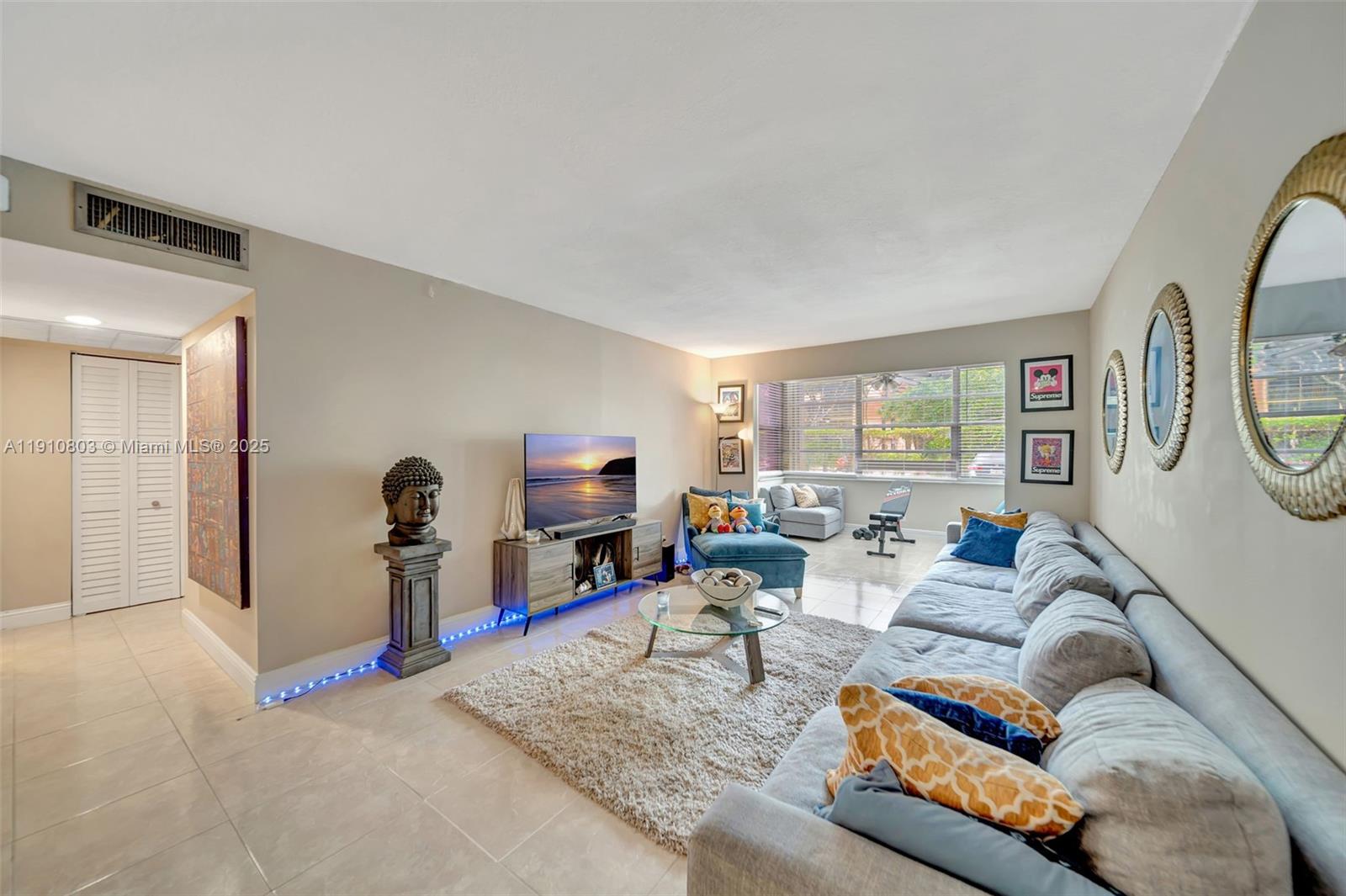 6700 Cypress Road, Unit 105 Plantation, FL 33317 - Photo 10 of 28 a living room with furniture and a flat screen tv