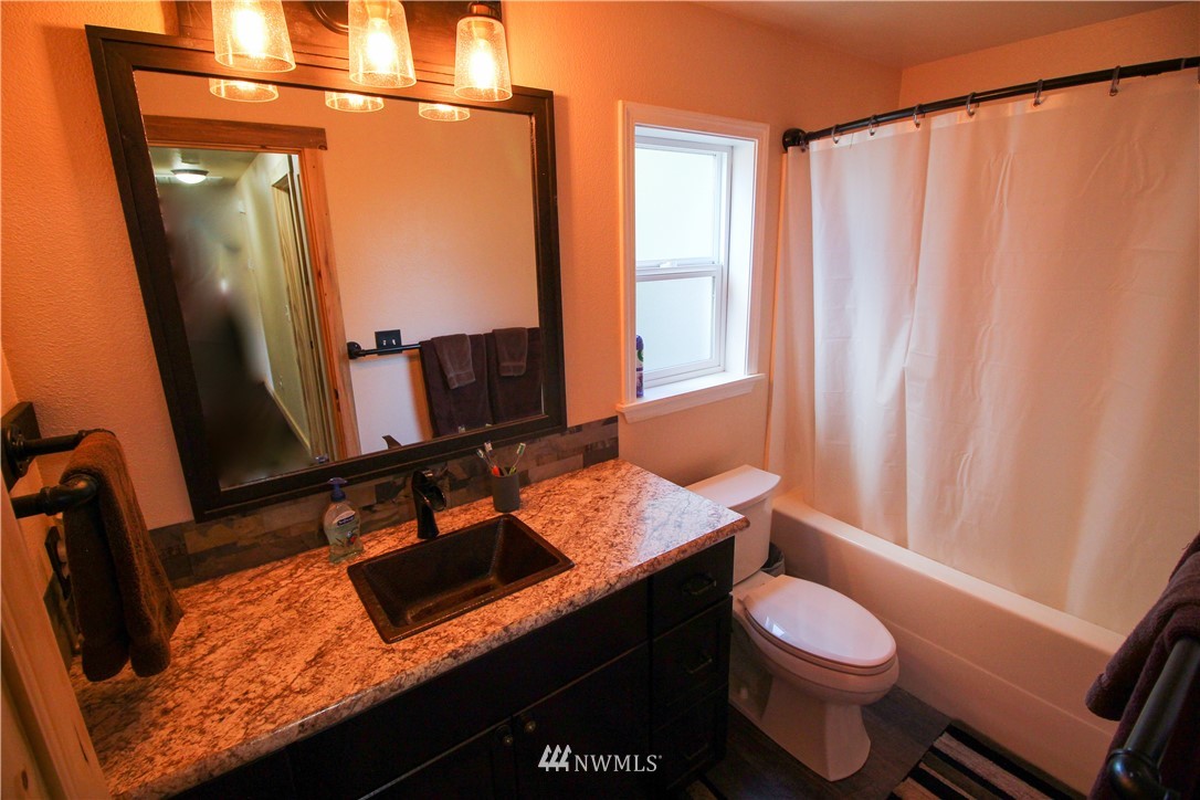 5432 188th Avenue Southwest Rochester, WA 98579 - Photo 14 of 31 a bathroom with a granite countertop sink toilet and mirror