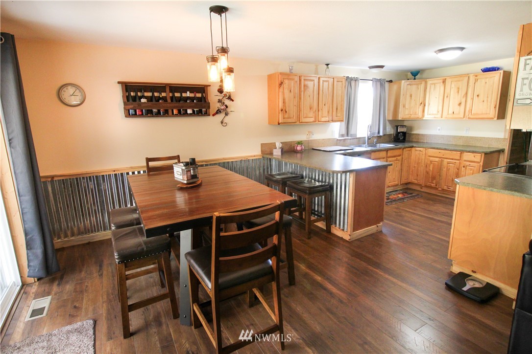 5432 188th Avenue Southwest Rochester, WA 98579 - Photo 5 of 31 a kitchen with a table chairs a sink dishwasher window and cabinets