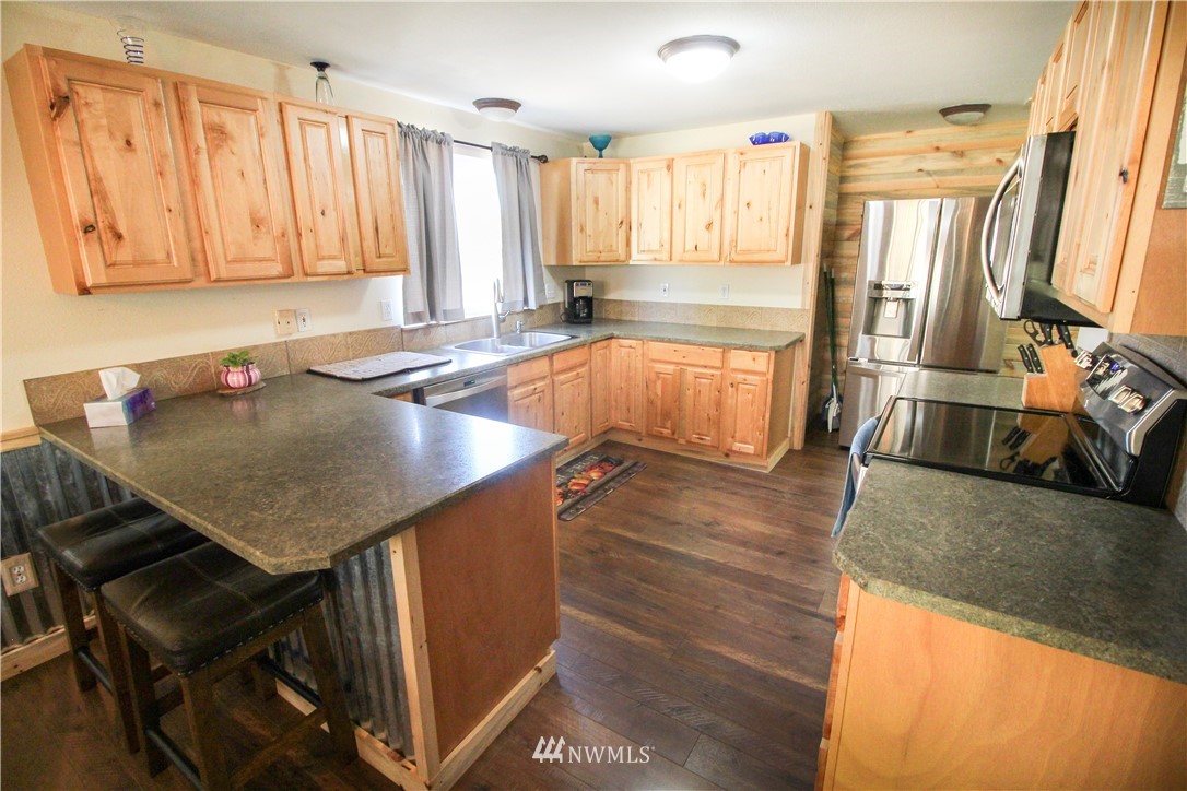 5432 188th Avenue Southwest Rochester, WA 98579 - Photo 6 of 31 a kitchen with a table chairs sink and cabinets