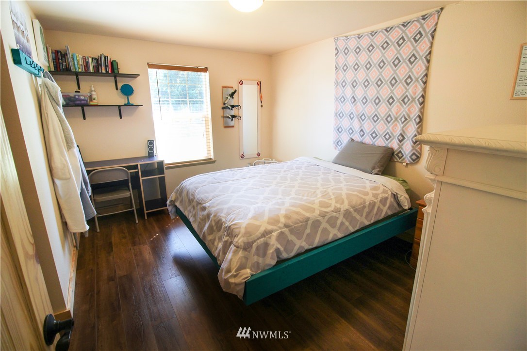 5432 188th Avenue Southwest Rochester, WA 98579 - Photo 10 of 31 a bedroom with a bed and wooden floor