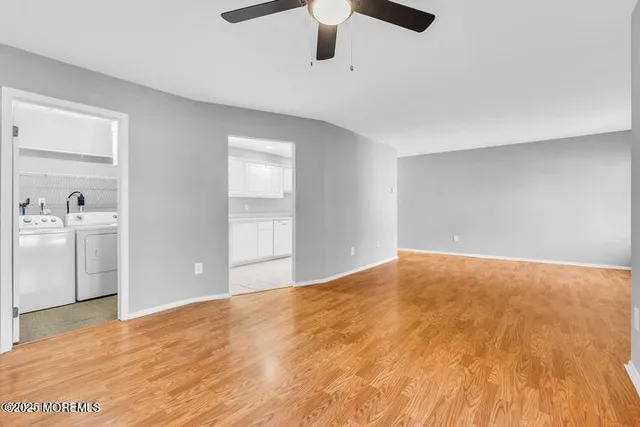 a view of empty room with ceiling fan