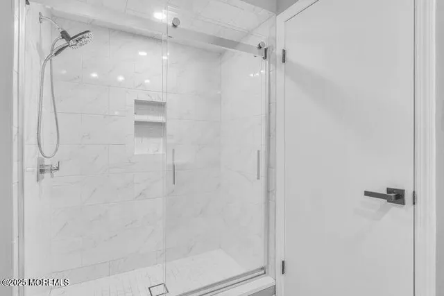 a bathroom with a glass shower door