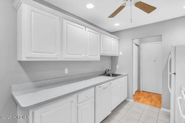 a kitchen with stainless steel appliances white cabinets and a sink