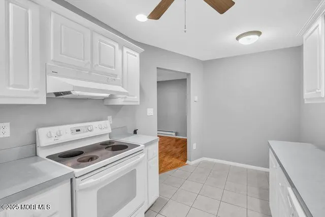 a kitchen with white cabinets and white appliances