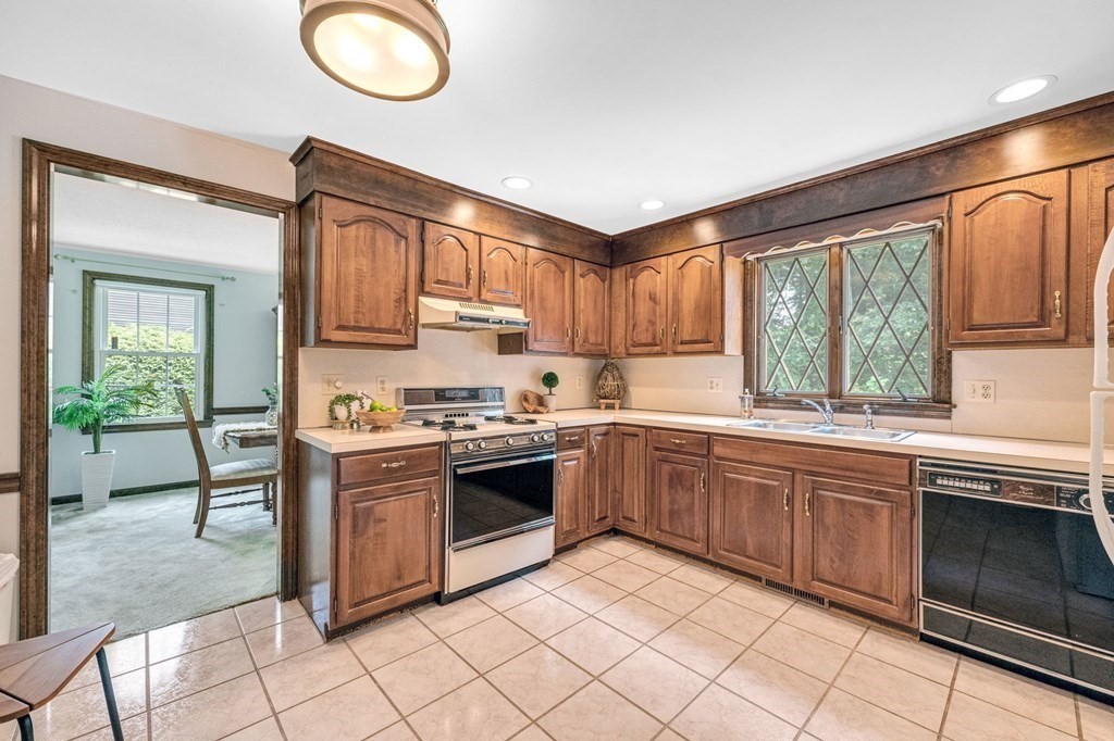 867 Shaker Road Longmeadow, MA 01106 - Photo 12 of 34 a kitchen with stainless steel appliances granite countertop a stove sink and cabinets