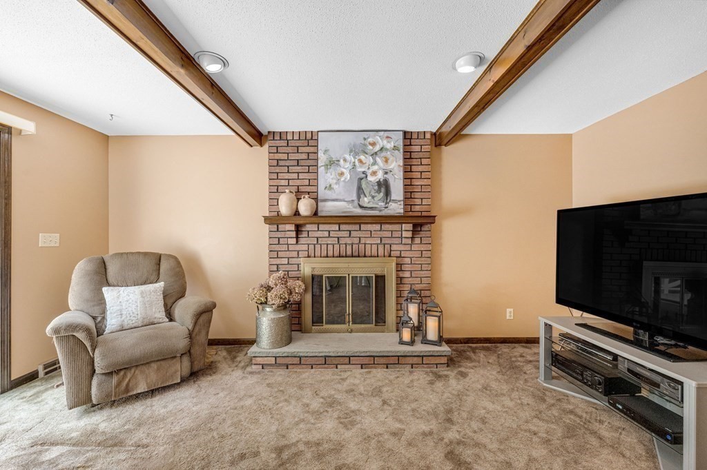 867 Shaker Road Longmeadow, MA 01106 - Photo 18 of 34 a living room with furniture a flat screen tv and a fireplace