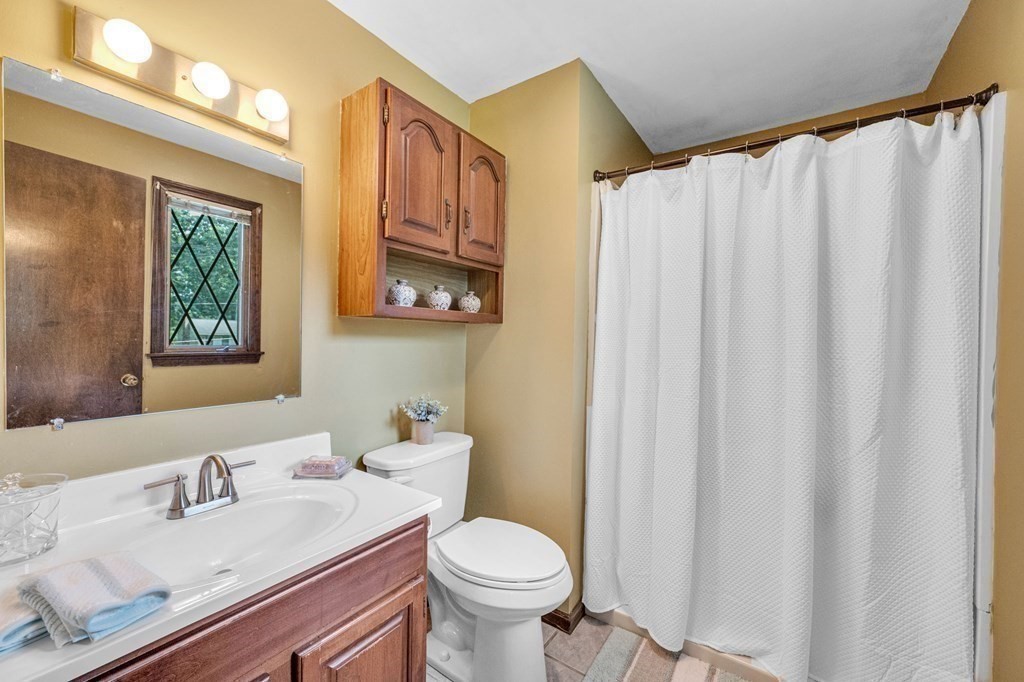 867 Shaker Road Longmeadow, MA 01106 - Photo 23 of 34 a bathroom with a granite countertop toilet sink and mirror