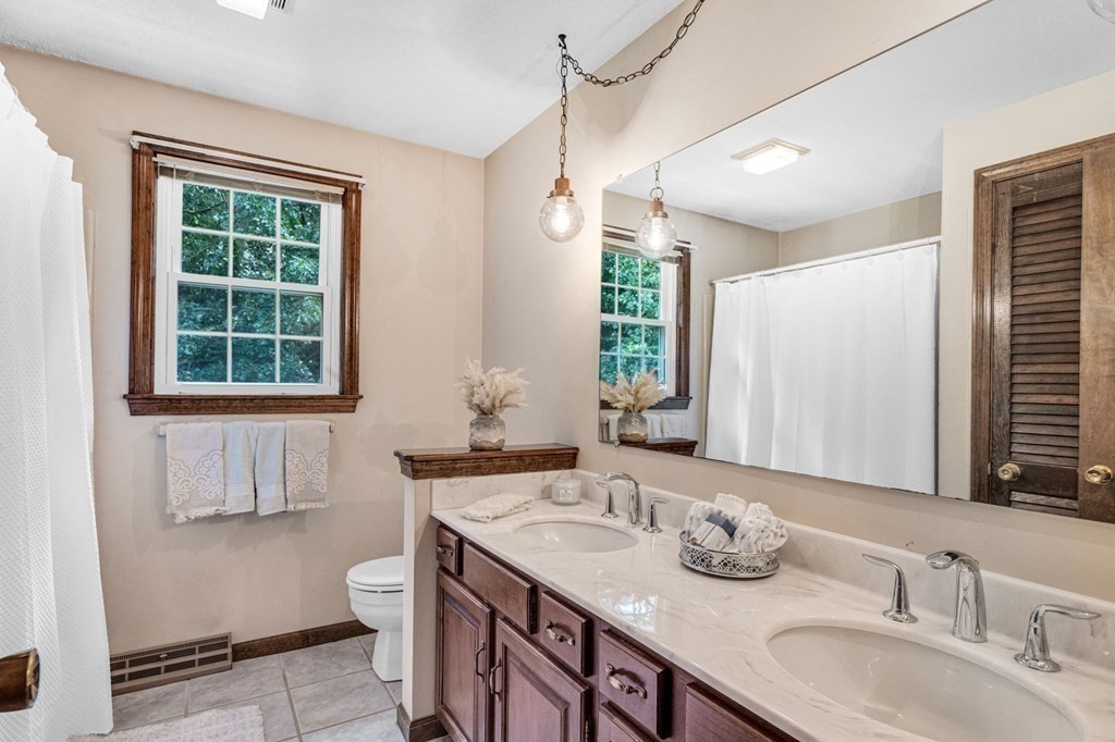 867 Shaker Road Longmeadow, MA 01106 - Photo 29 of 34 a bathroom with a granite countertop sink and a window