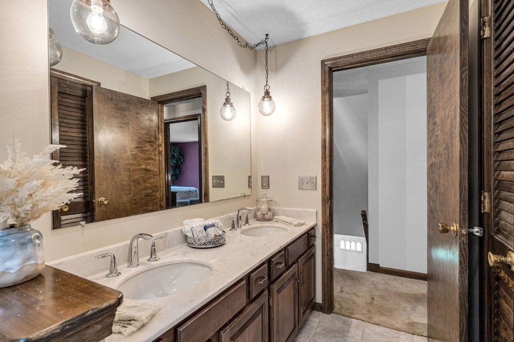 867 Shaker Road Longmeadow, MA 01106 - Photo 30 of 34 a bathroom with a sink double vanity and a mirror