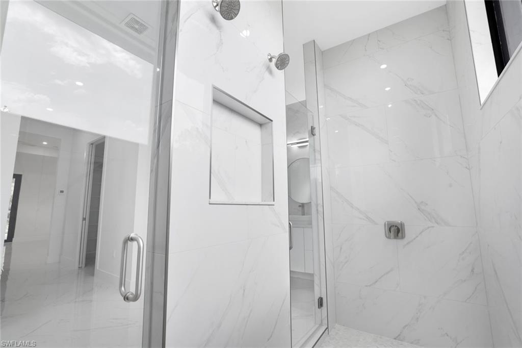 1068 16th Street Northeast Naples, FL 34120 - Photo 16 of 35 a bathroom with a shower and a glass door