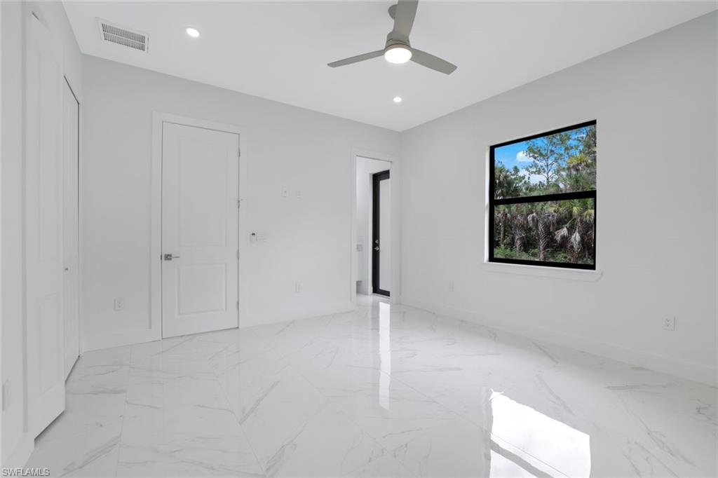 1068 16th Street Northeast Naples, FL 34120 - Photo 17 of 35 an empty room with fan and windows