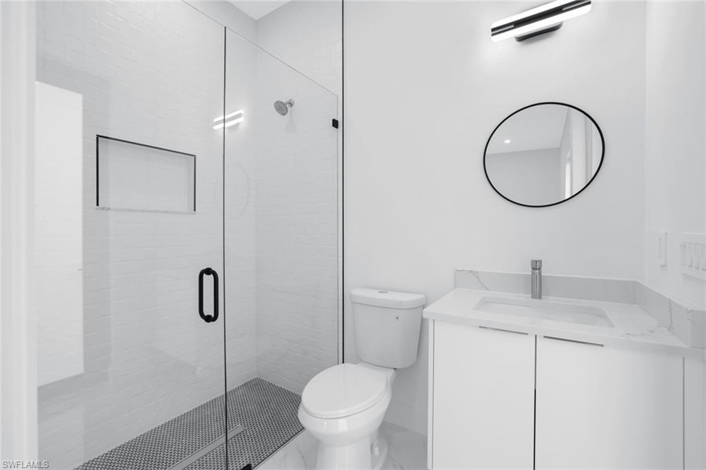 1068 16th Street Northeast Naples, FL 34120 - Photo 18 of 35 a bathroom with a toilet sink and a shower