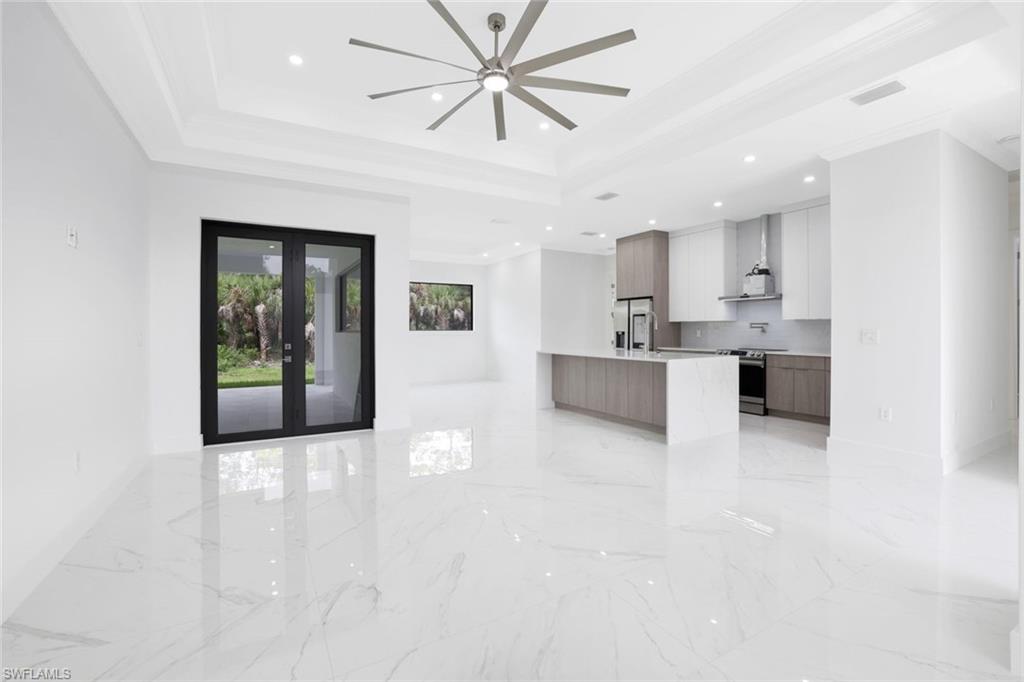 1068 16th Street Northeast Naples, FL 34120 - Photo 2 of 35 a view of a kitchen with kitchen island and stainless steel appliances
