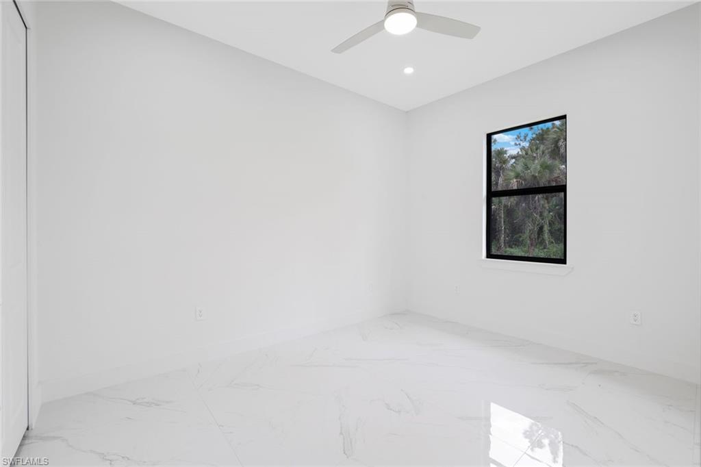 1068 16th Street Northeast Naples, FL 34120 - Photo 21 of 35 an empty room with windows