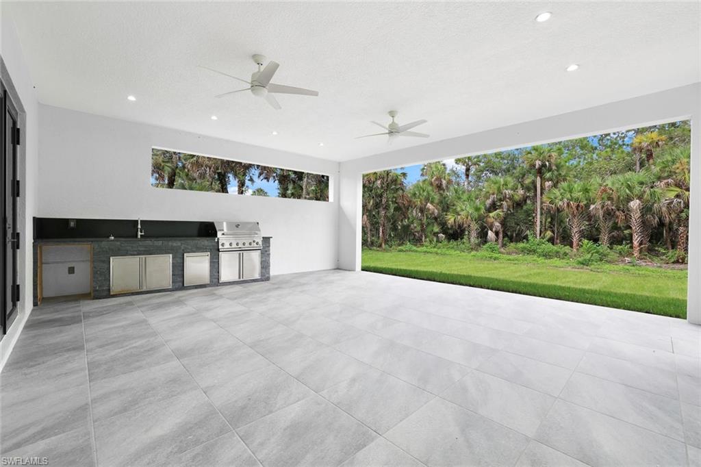 1068 16th Street Northeast Naples, FL 34120 - Photo 26 of 35 a view of a porch with a yard