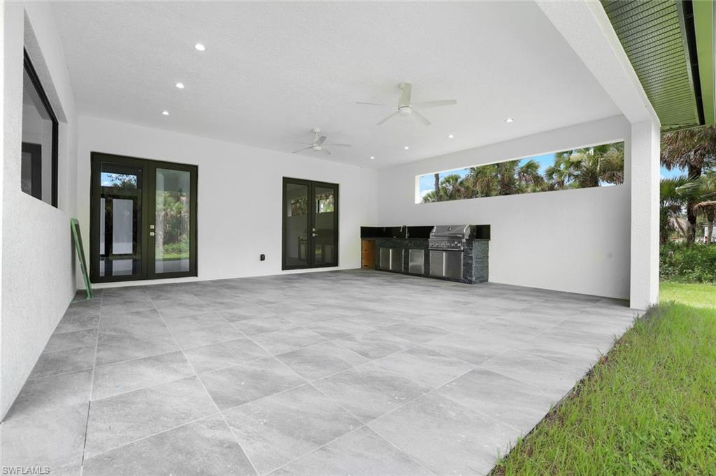1068 16th Street Northeast Naples, FL 34120 - Photo 27 of 35 a view of an empty room with a kitchen