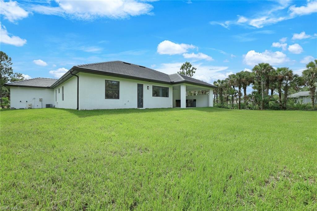 1068 16th Street Northeast Naples, FL 34120 - Photo 30 of 35 a view of a house with a big yard