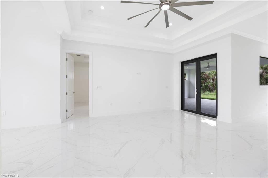 1068 16th Street Northeast Naples, FL 34120 - Photo 3 of 35 a view of an empty room with chandelier fan