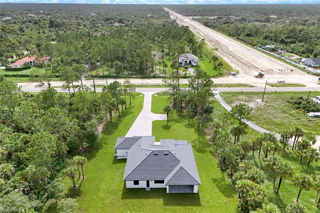 1068 16th Street Northeast Naples, FL 34120 - Photo 32 of 35 an aerial view of house with yard swimming pool and outdoor seating