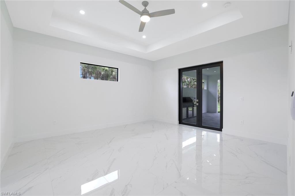 1068 16th Street Northeast Naples, FL 34120 - Photo 10 of 35 an empty room with closet and a ceiling fan