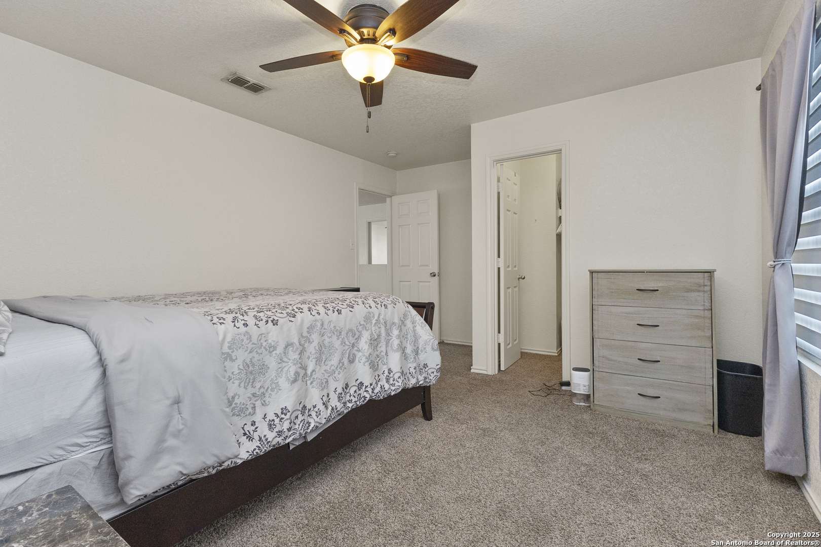 707 Ridingate Farm San Antonio, TX 78228 - Photo 15 of 30 a bedroom with a bed and a ceiling fan