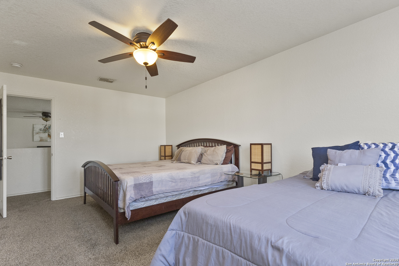 707 Ridingate Farm San Antonio, TX 78228 - Photo 21 of 30 a bedroom with two bed and window
