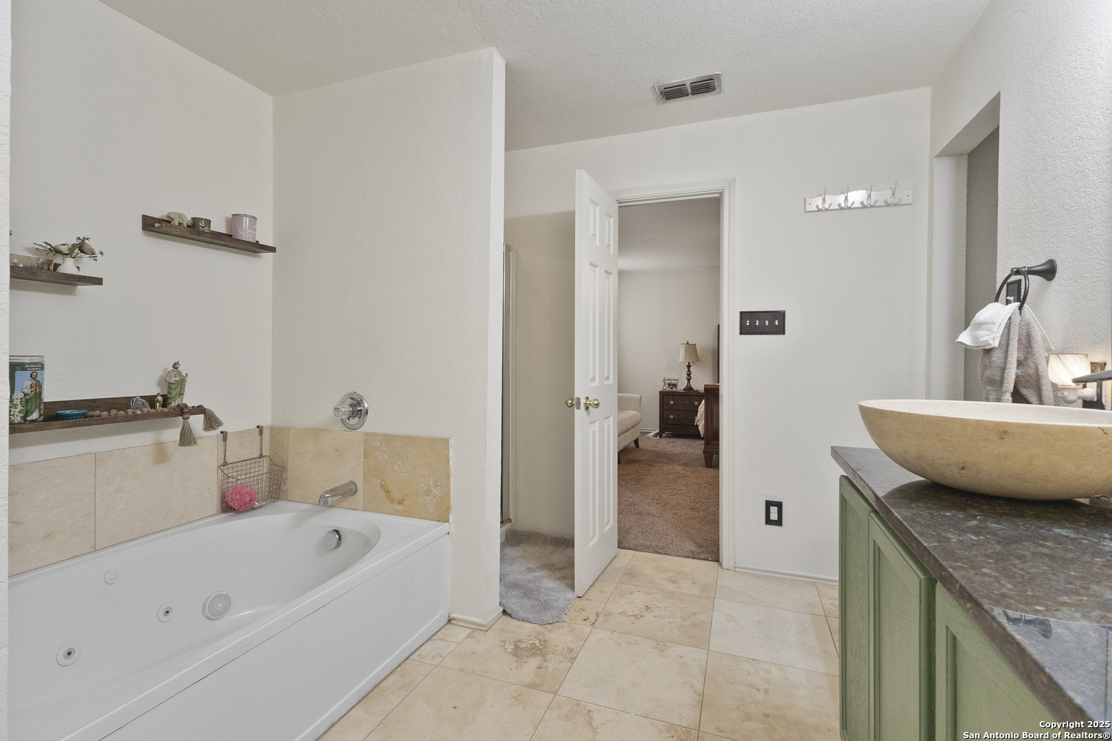 707 Ridingate Farm San Antonio, TX 78228 - Photo 26 of 30 a en suite bathroom with a granite countertop tub and a sink