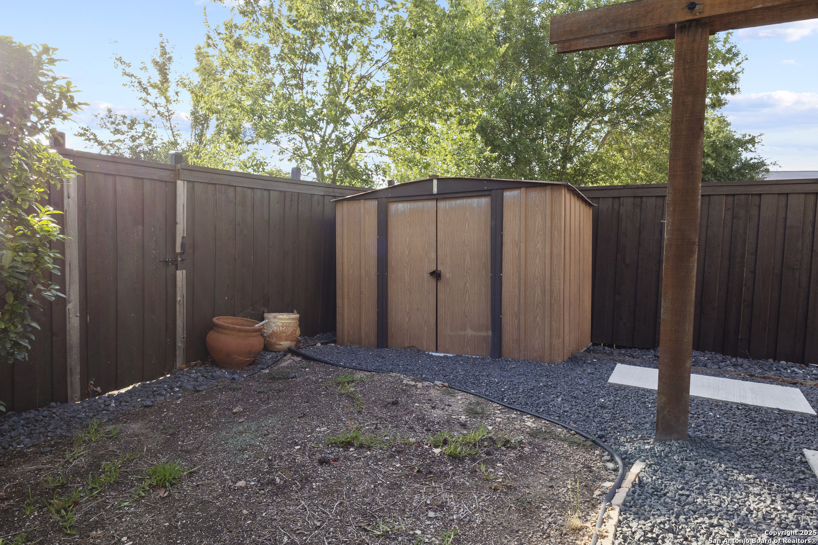 707 Ridingate Farm San Antonio, TX 78228 - Photo 30 of 30 a backyard of a house with table and chairs