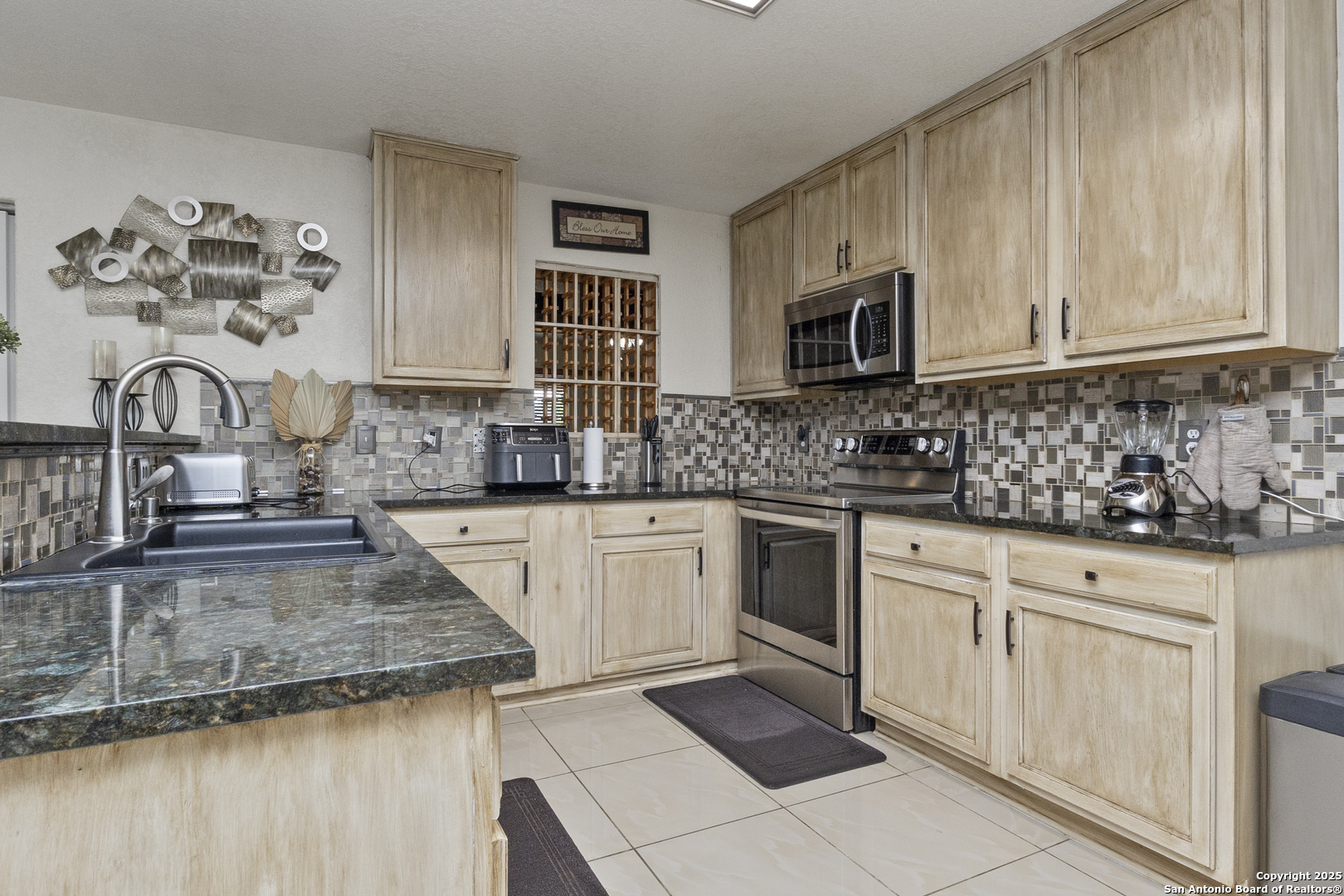 707 Ridingate Farm San Antonio, TX 78228 - Photo 5 of 30 a kitchen with sink cabinets and microwave