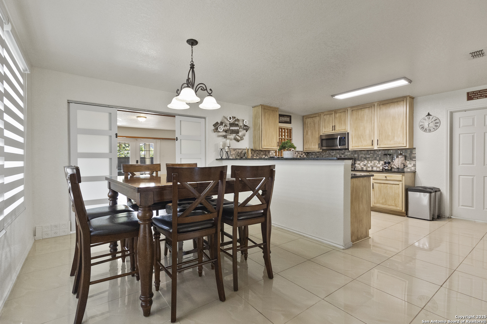 707 Ridingate Farm San Antonio, TX 78228 - Photo 6 of 30 a kitchen with stainless steel appliances a dining table chairs and granite counter tops