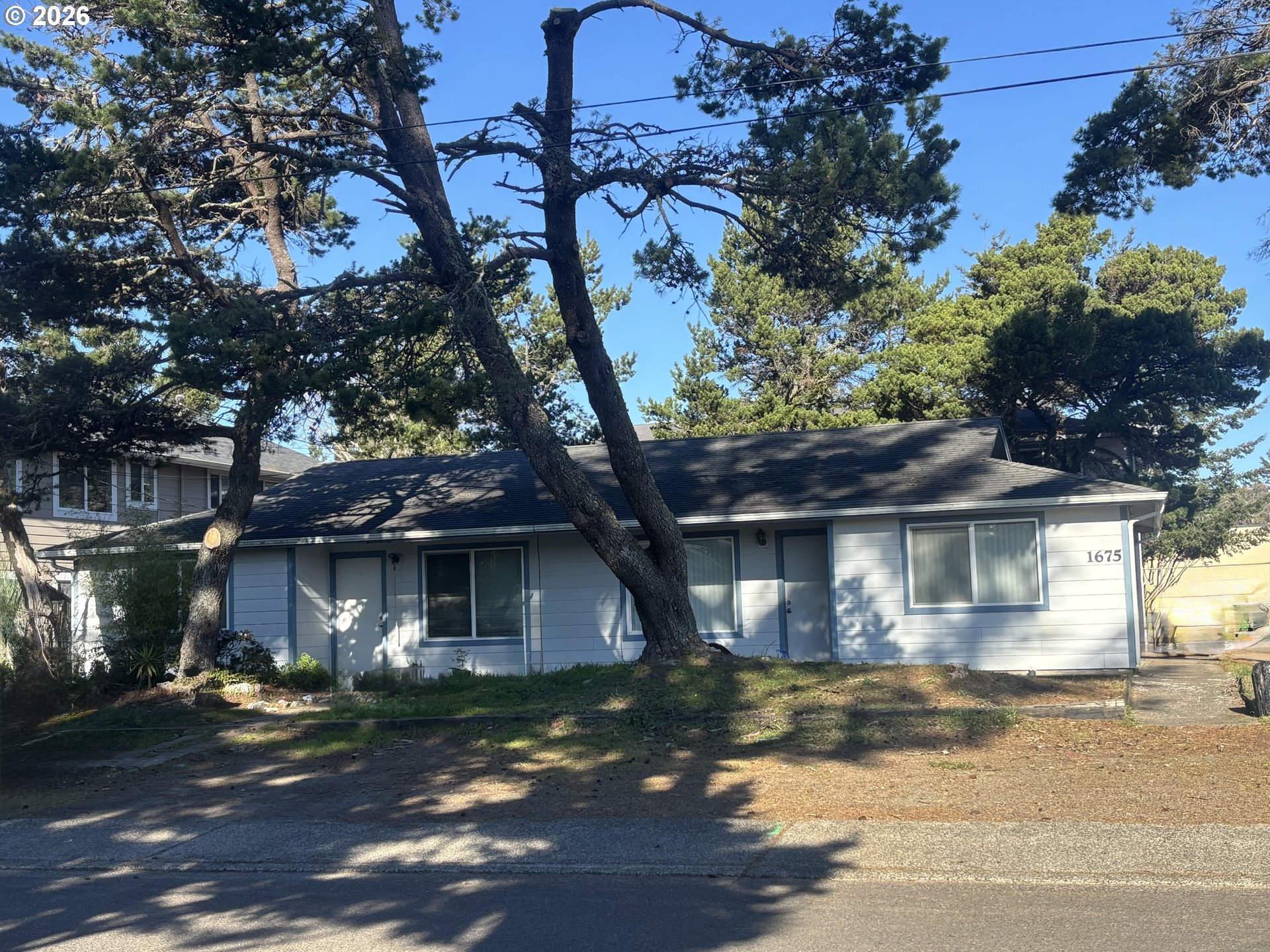 a front view of a house with a garden
