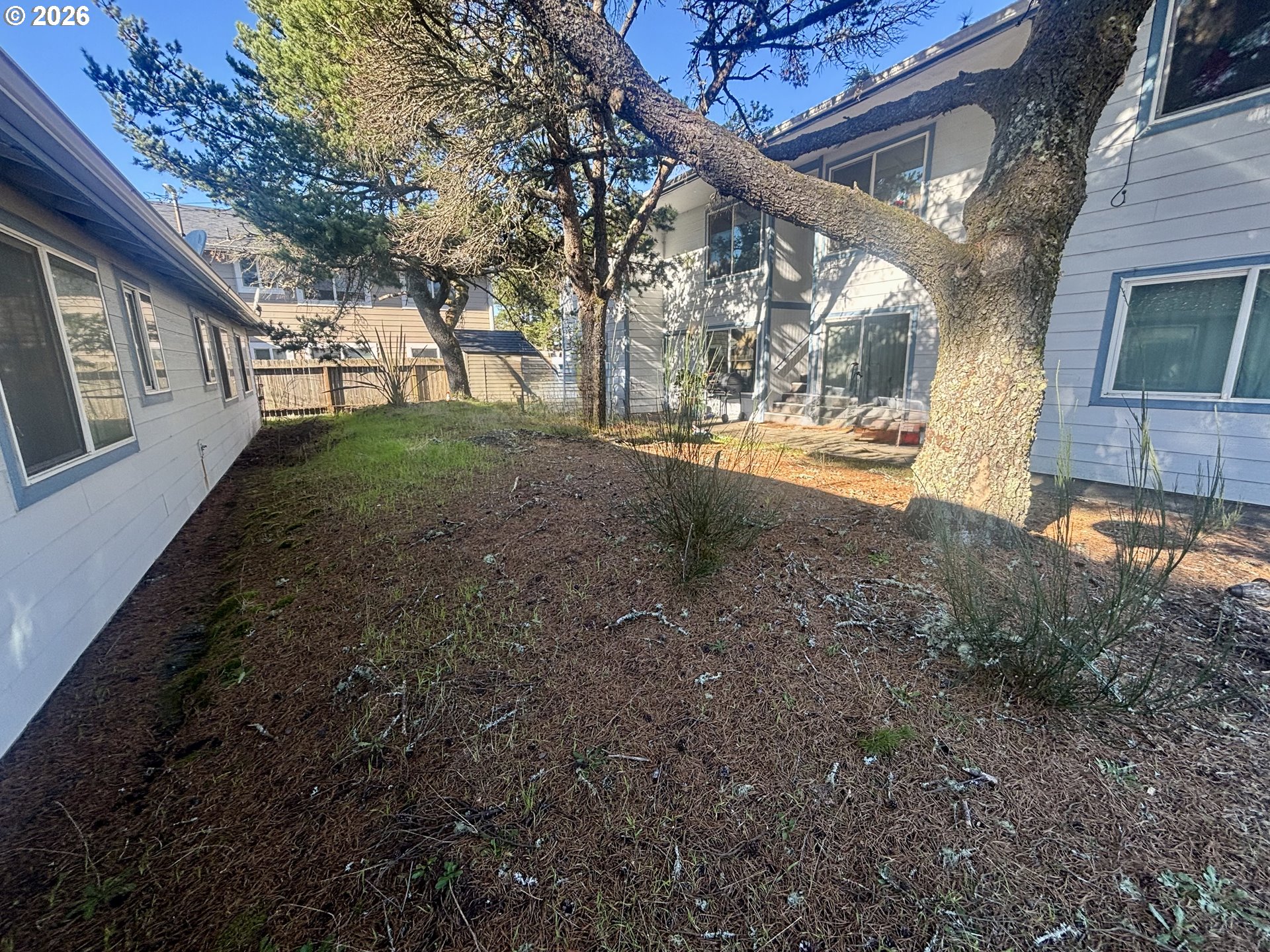 1675 22nd Street Florence, OR 97439 - Photo 2 of 7 a view of a yard with a house