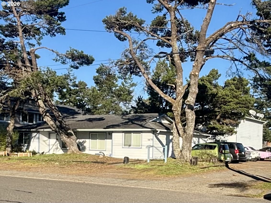 1675 22nd Street Florence, OR 97439 - Photo 6 of 7 front view of a house with a tree