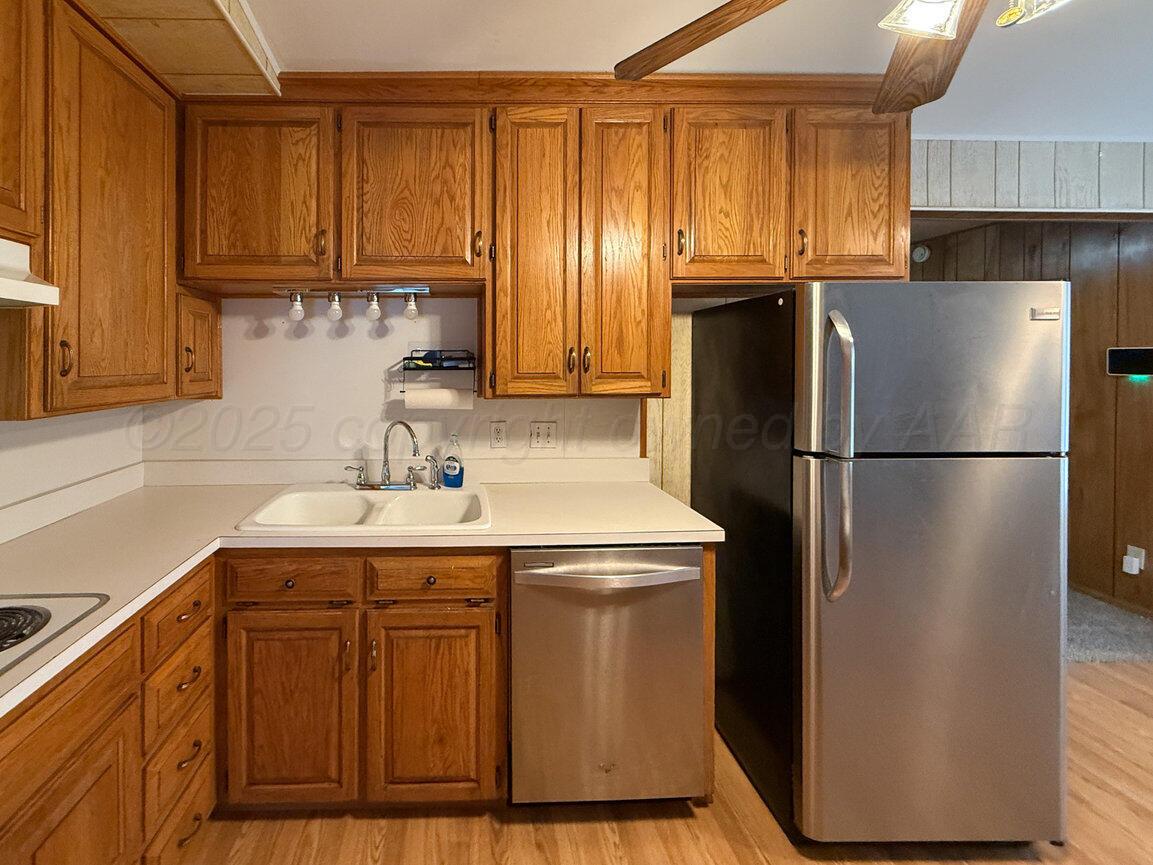 1133 Elmore Street Borger, TX 79007 - Photo 11 of 43 a kitchen with stainless steel appliances granite countertop a refrigerator a sink and a cabinets