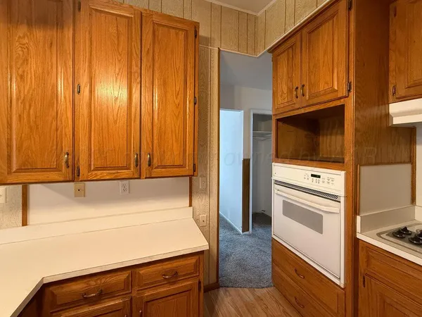 a kitchen with a refrigerator stove and cabinets
