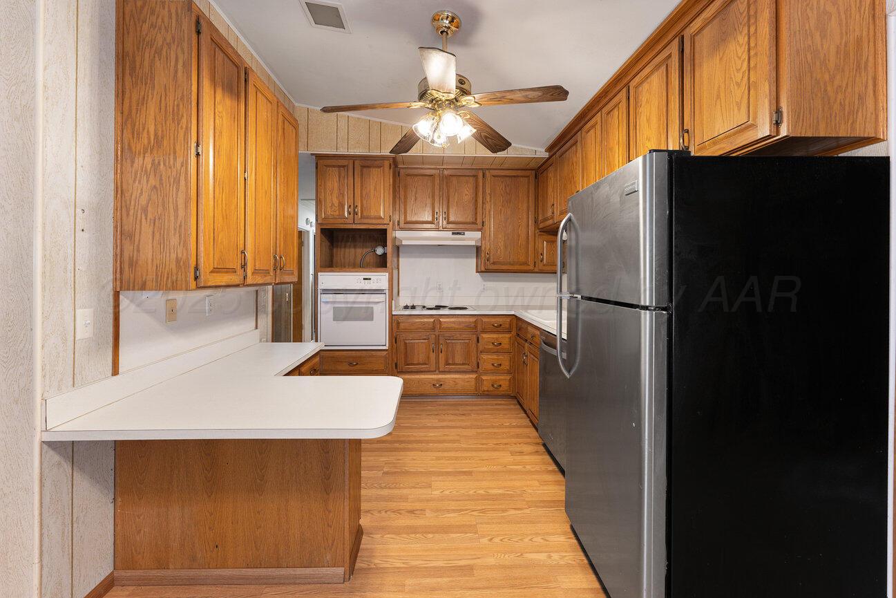 1133 Elmore Street Borger, TX 79007 - Photo 13 of 43 a kitchen with stainless steel appliances a refrigerator and a stove